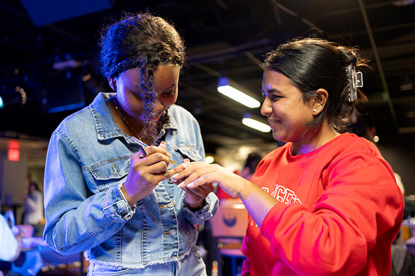 Two female students at a campus function