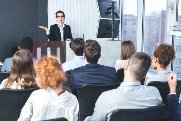 Female business woman speaks to collegues
