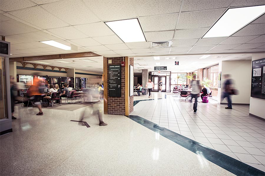 Blurred long exposure photo of students walking through the underground hallways