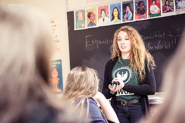 A UWGB student speaks to a classroom of kids.