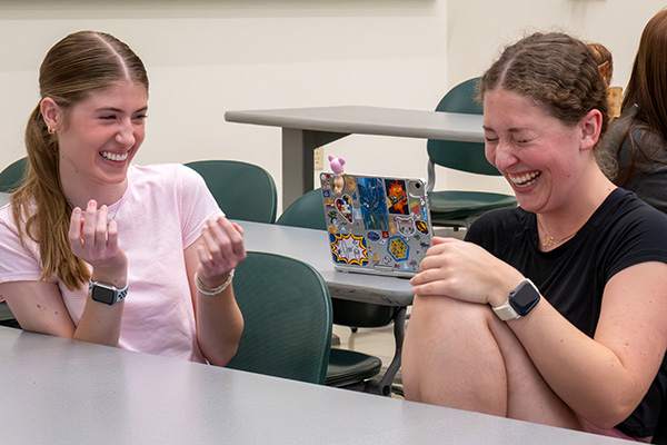 Students laughing together in classroom