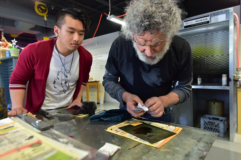 Professor Beryl Lutsky of UWGB, Manitowoc campus in the printmaking studio with a student.