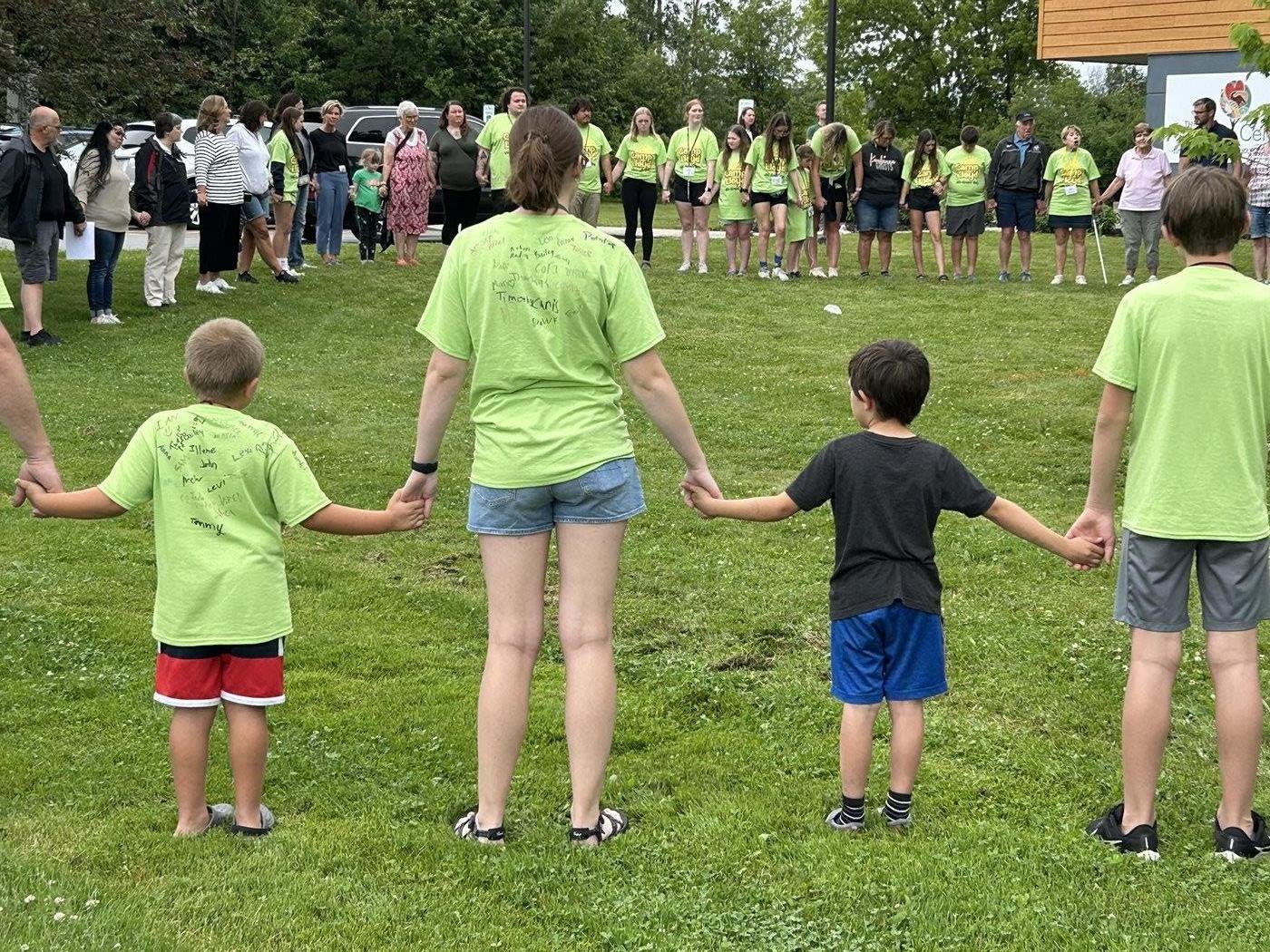 Campers holding hands in a circle