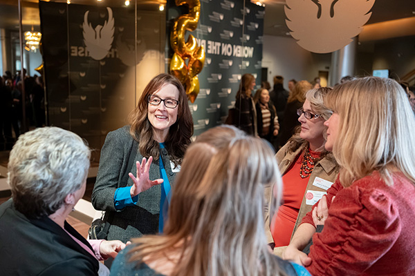 Group of happy women conversing at a conference