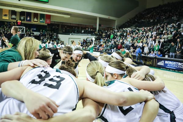 UWGB girls basketball team huddle during game