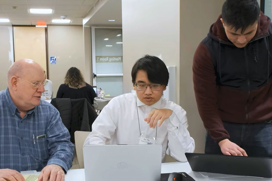 Two students help complete a taxpayer form.