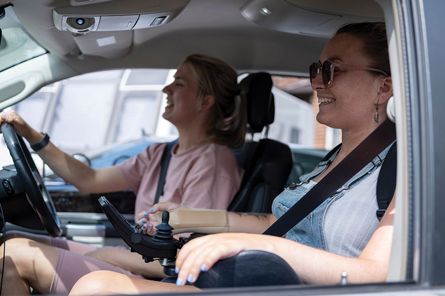 People in a car with wheelchair accessible seating.