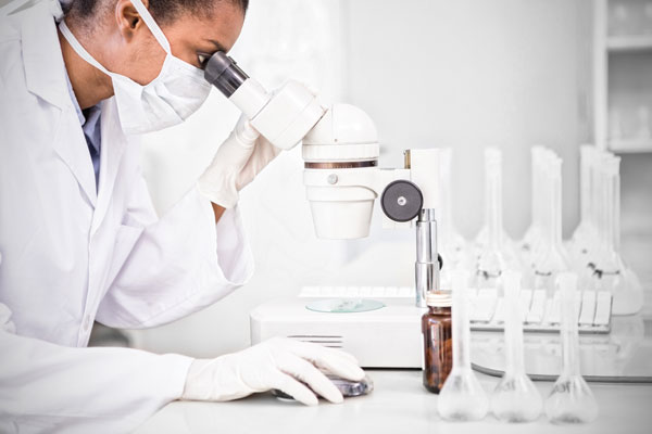 Female biologist looks into microscope