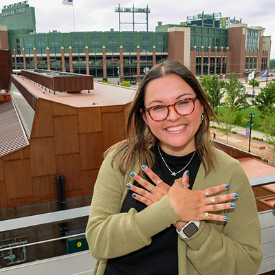 UW-Green Bay graduate Majriela Moreno poses in front of Lambeau Field.