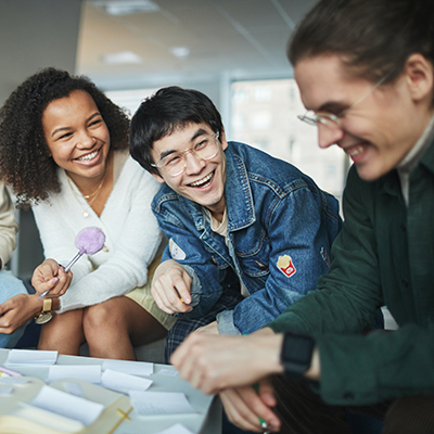 Students laugh as they work on a group project.