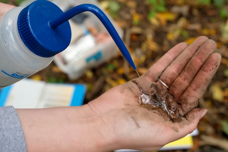 Close up of student testing soil samples