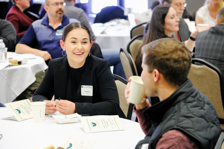 Male and female students talk at campus event