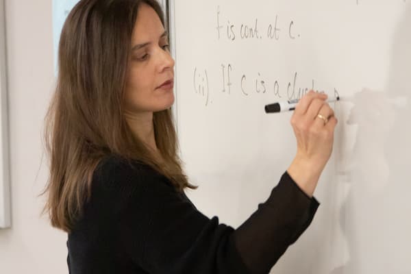 Woman works on math equations