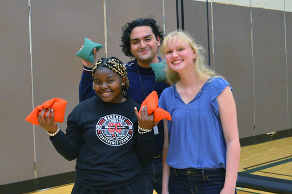 students playing bean bag toss