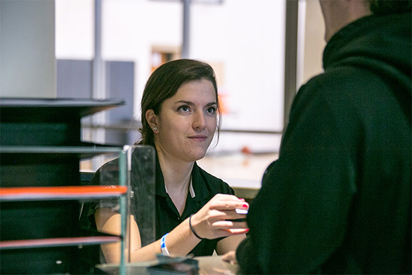 Front desk attendant returning a guest's ID