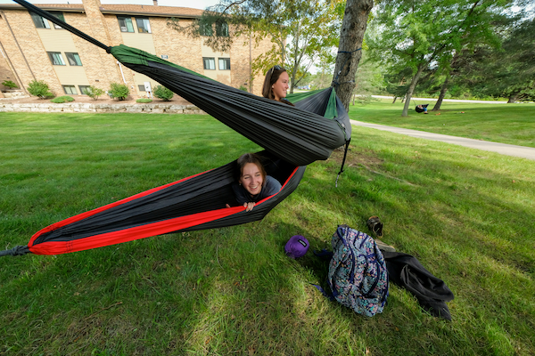 students hanging out in the hammocks