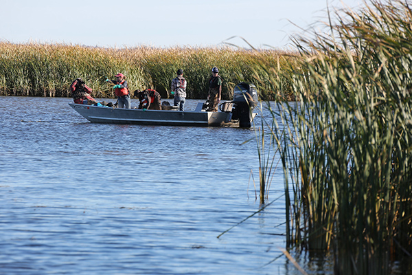 People in small fishing boat on a river