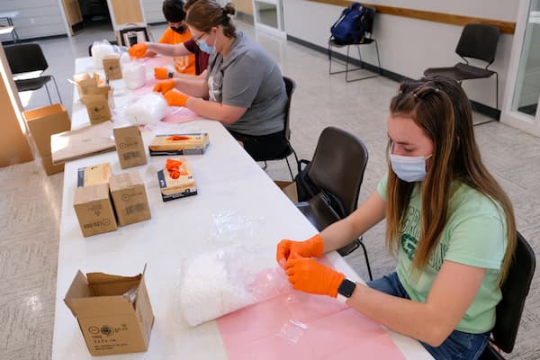 UW-Green Bay Day of service volunteers helping to pack health kits