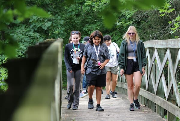 Campers walking over bridge