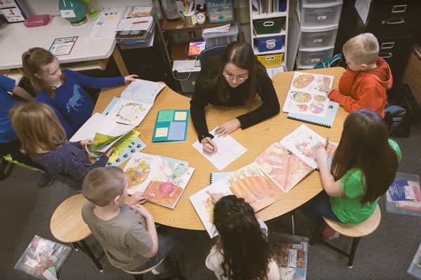 Education student working with children in classroom