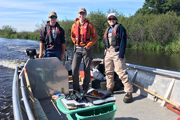 3 field crew members in boat