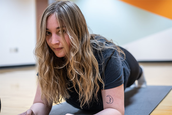 Student holiding an isometric plank in the uwgb group fitness studio