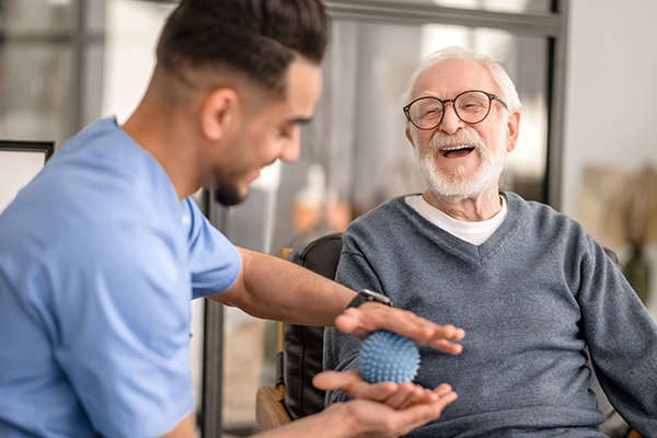 Young man providing physical therapy to older man