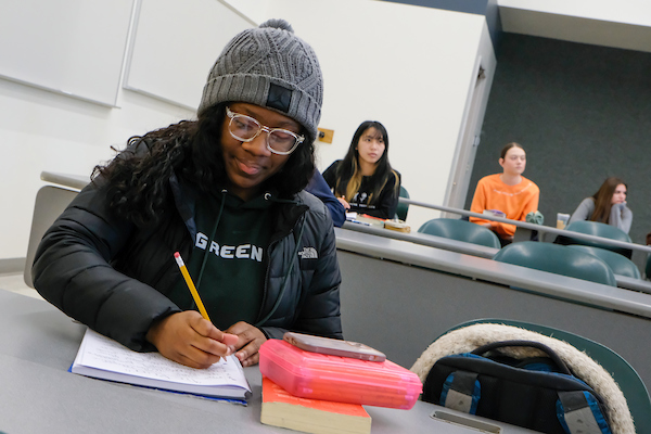 UW-Green Bay student taking notes in class