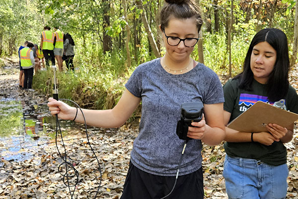 Students working in creek