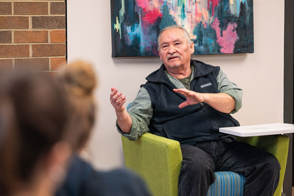 Students listen to elder speak