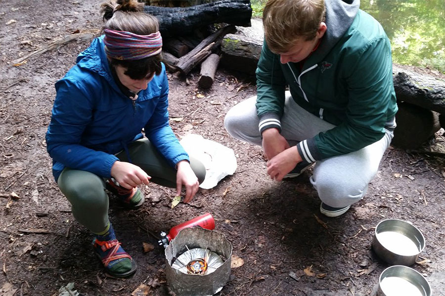 Students using UREC pack stove camping equipment