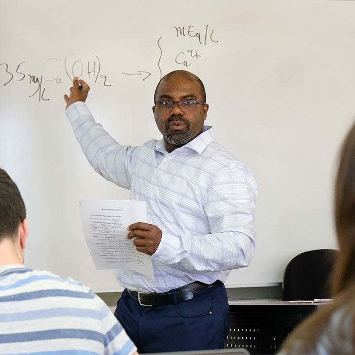 Stephan (Kpoti) Gunn teaches how to calculate water concentrations in class.