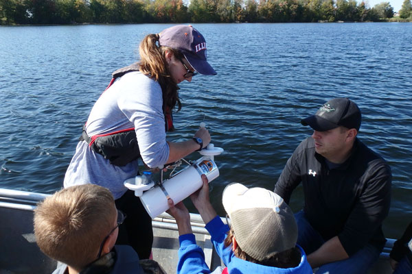 Student and professor on boat testing water