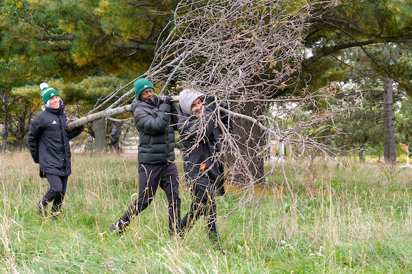 Students participating in brush clean up on UW-Green Bay Day of Service