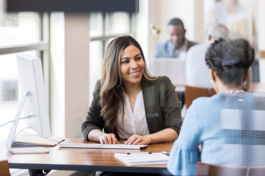 woman clerk sitting across from resident