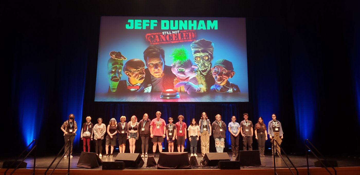 Stagehand Campers standing on a stage.