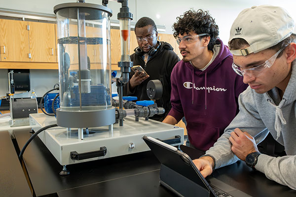 UWGB Engineering students run experiments on parallel pumps fluid mechanics equipment during Fluids Lab