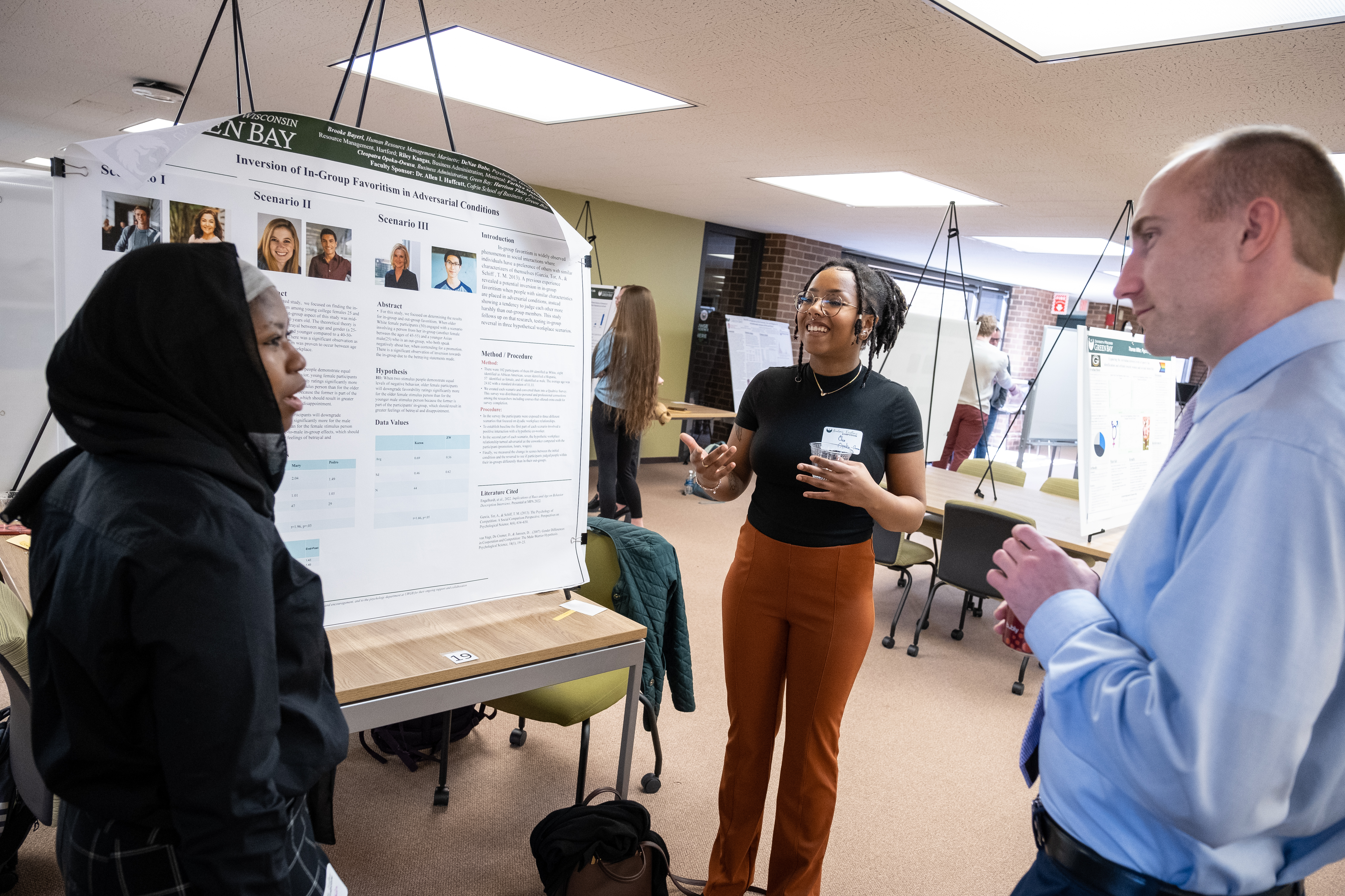 three people looking at a poster