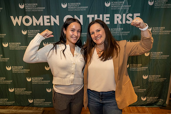 two women making the Accelerate Action pose