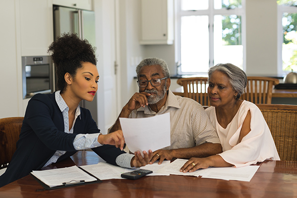 Realtor reviewing numbers with clients