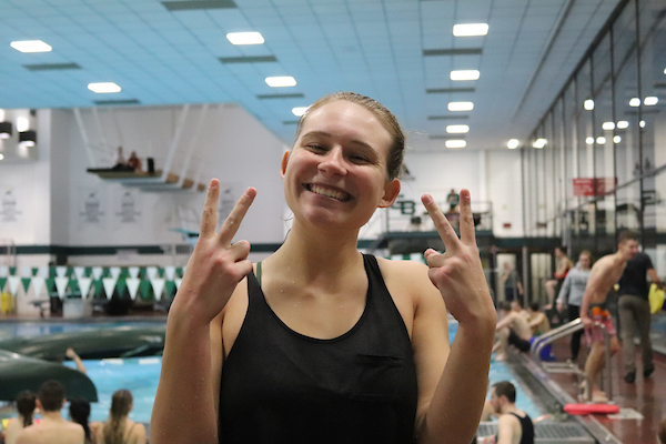 Swim coach gives peace sign