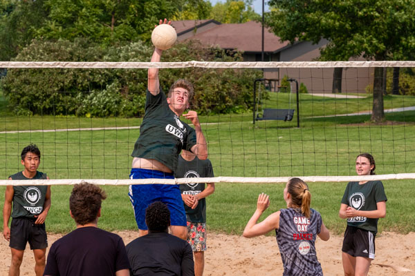 Students play coed intramural volleyball