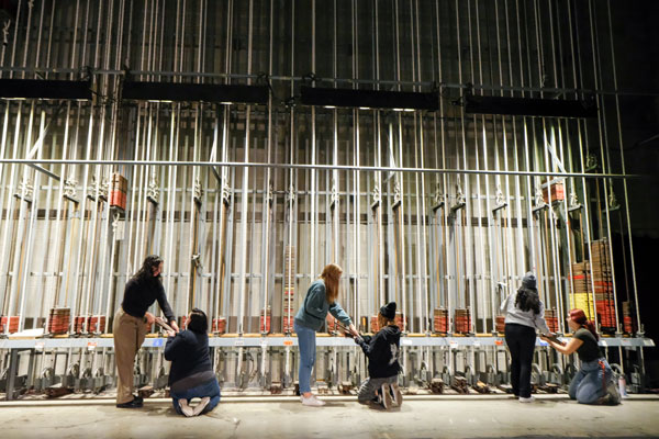 Stage crew works on behind the scenes mechanics