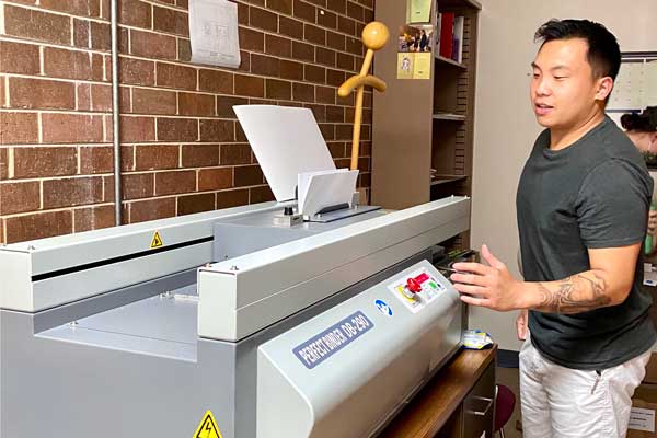 Male student works with printing press