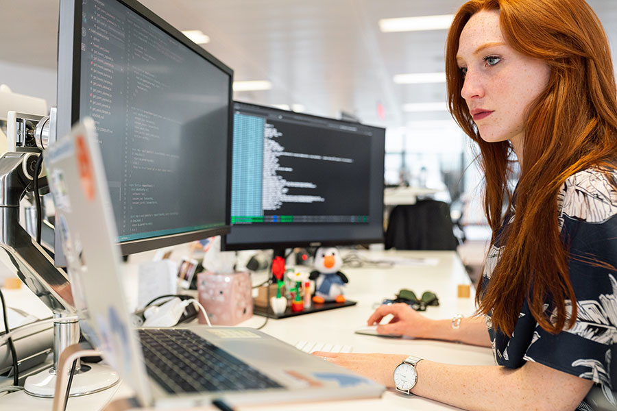 Corporate intern working on a computer in an office