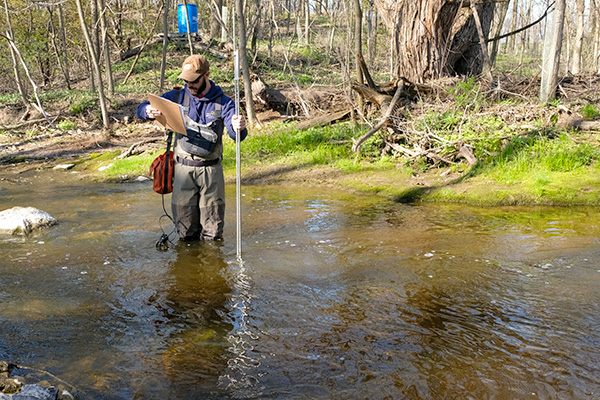 Surveyor checking water levels