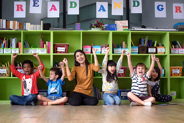 Teacher with cheering students