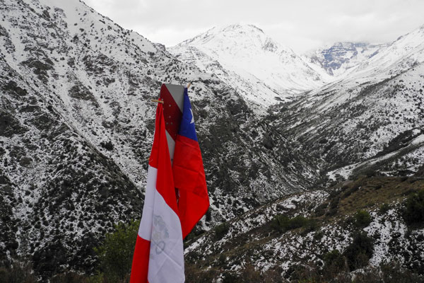 Chile's flag amongst snow capped mountains 