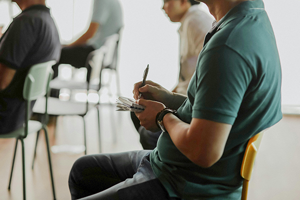 Person taking notes in a chair