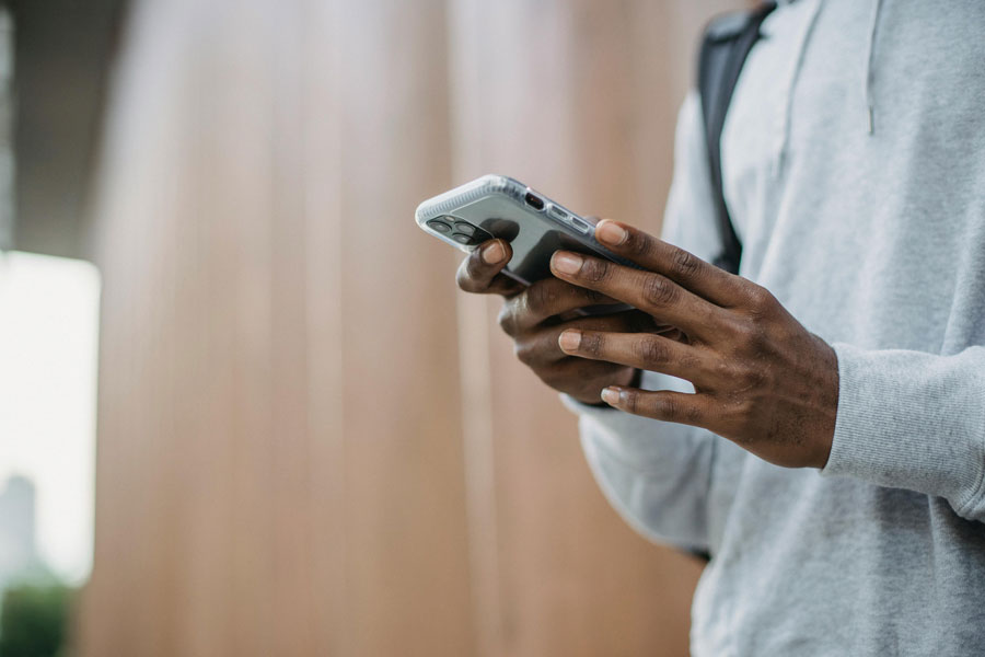 Student checking alerts on mobile phone